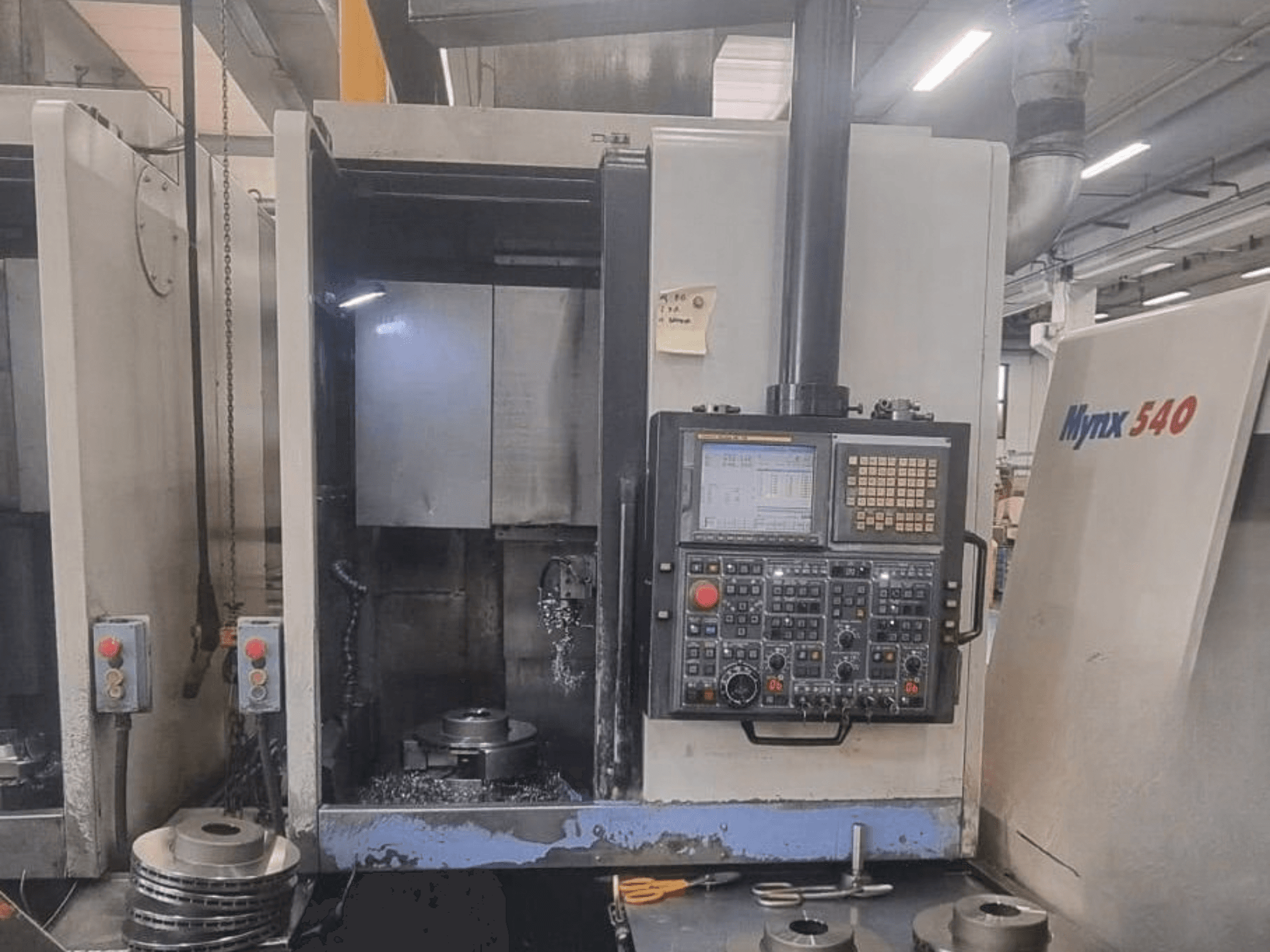 DOOSAN PUMA V400-2SP dikey torna tezgahının önden görünümü; bu görselde kontrol paneli ve tezgahın içindeki iş parçası yerleşimi gösterilmektedir.
