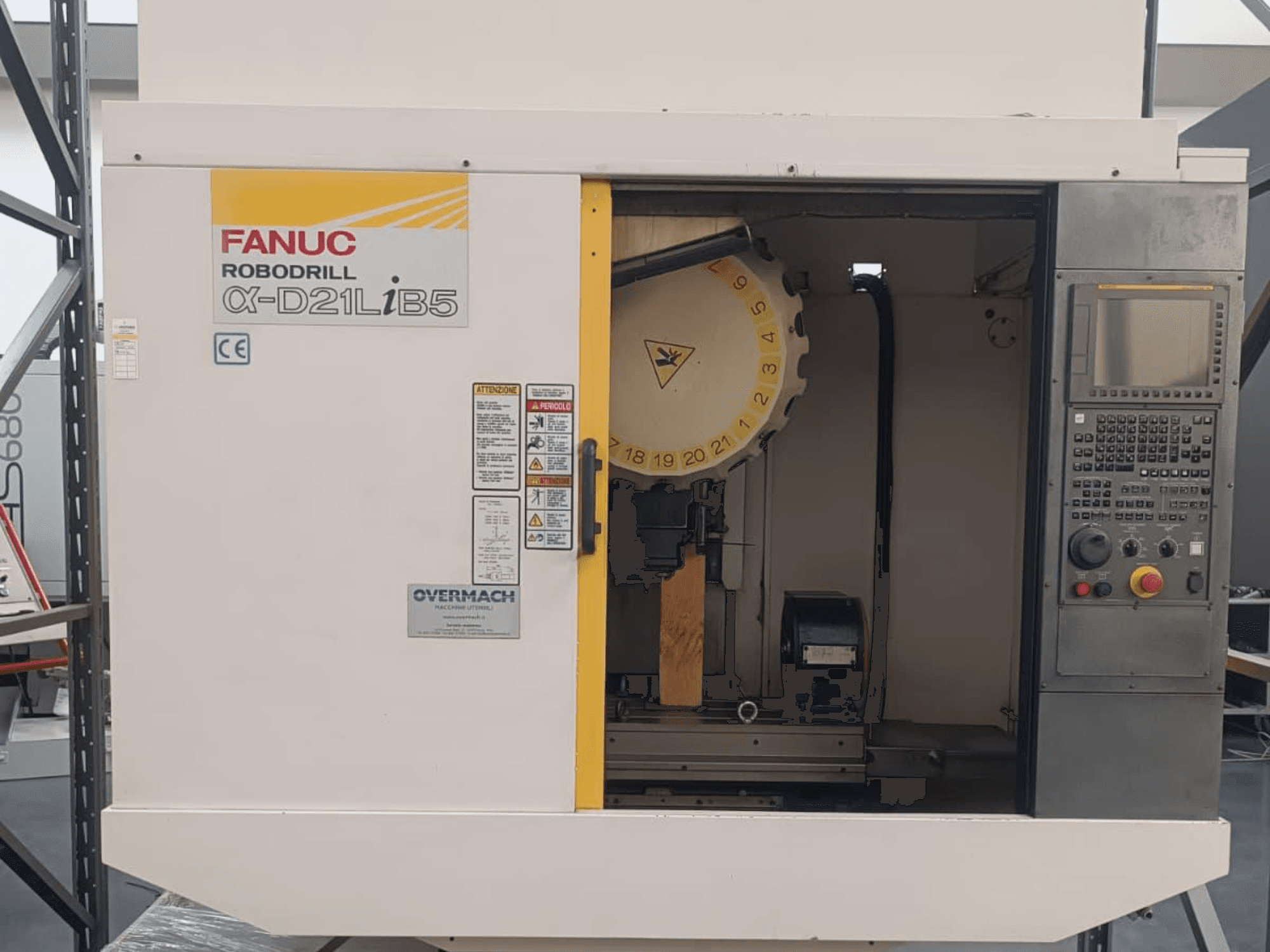 FANUC Robodrill α-D21LiB5, önden görünüm; takım tutucu, kontrol paneli ve güvenlik uyarıları görünen CNC makinesi.