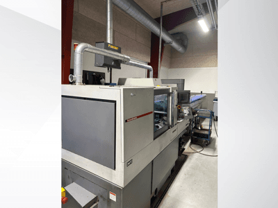 MVC markalı endüstriyel makine, kontrol paneli ve kanal sisteminin göründüğü yandan görünüm, fabrika ortamında.