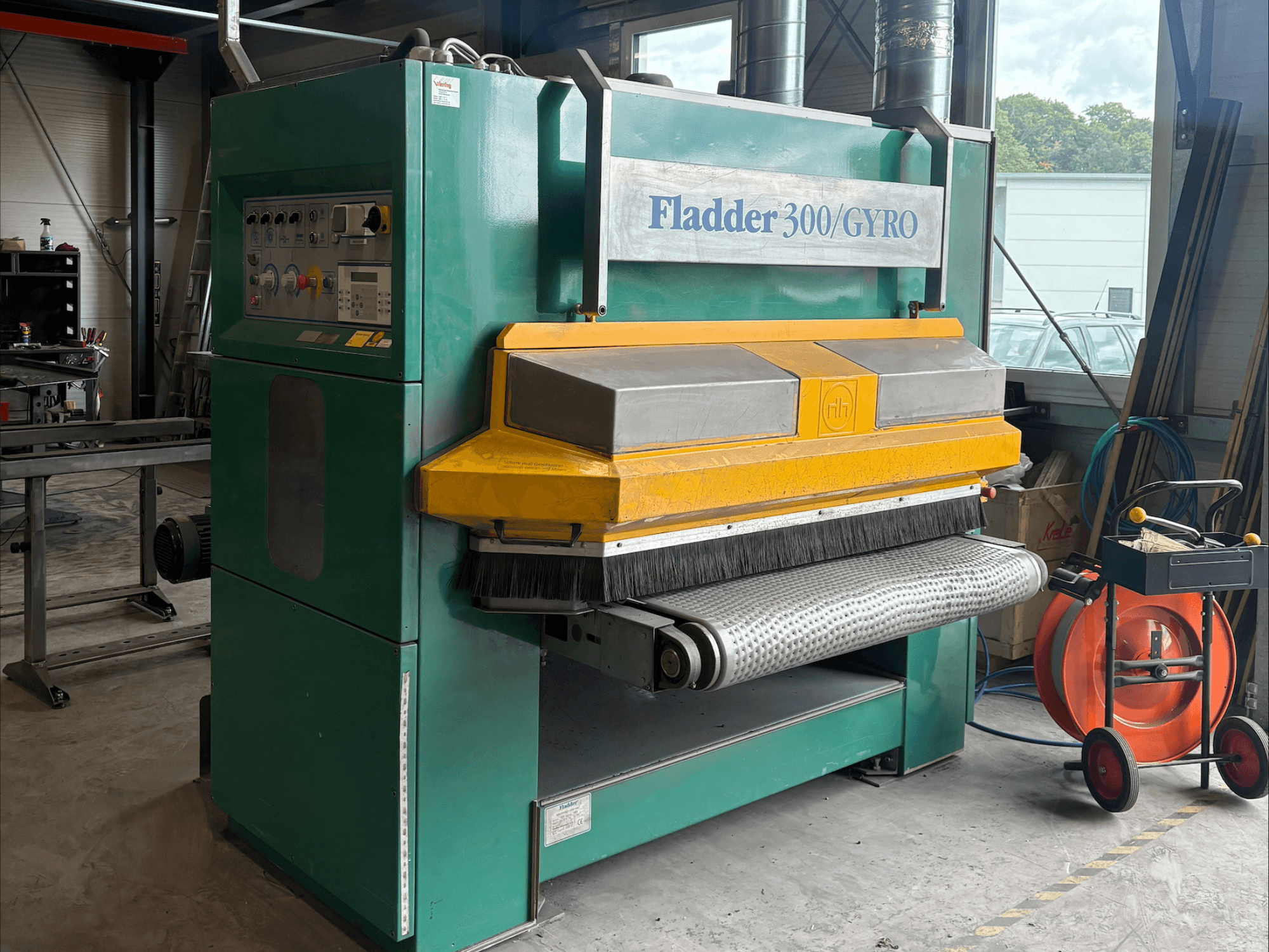 Yeşil ve sarı renkli Fladder 300/GYRO endüstriyel zımpara makinesi, önden görünüm, kontrol paneli ve zımpara tamburu.