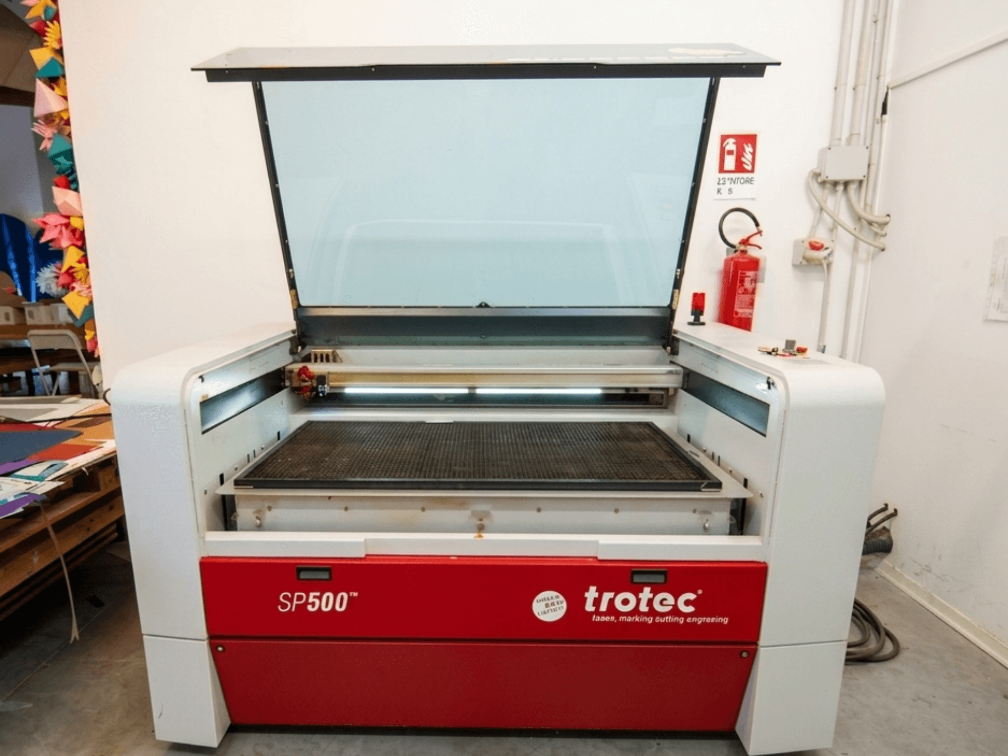 Trotec SP500 C200 lazer kazıma makinesinin önden görünümü, çalışma alanını ve kontrolleri gösteren açık kapak.