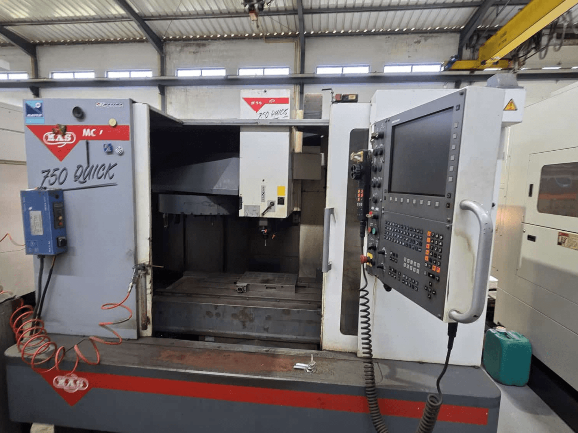 Dikey işleme merkezi KOVOSVIT MAS MCV 750, kontrol paneli ve çalışma alanını gösteren önden görünüm, "750 Quick" etiketi ile.