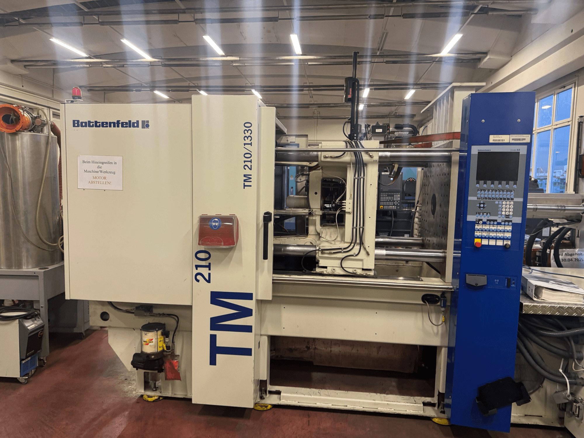 Battenfeld TM 210/1330 hidrolik enjeksiyon kalıplama makinesi, önden görünüm, kontrol paneli ve makine bileşenlerini gösterir.