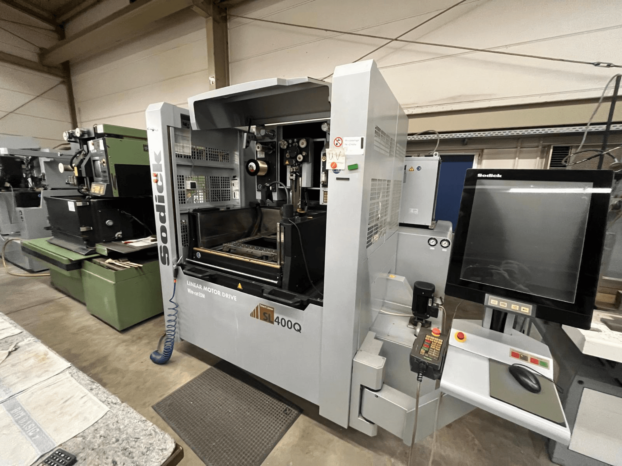 Sodick SL400Q lineer motor sürücülü CNC makinesi, atölye ortamında dijital kontrol paneli ve ekran ile önden görünüm.