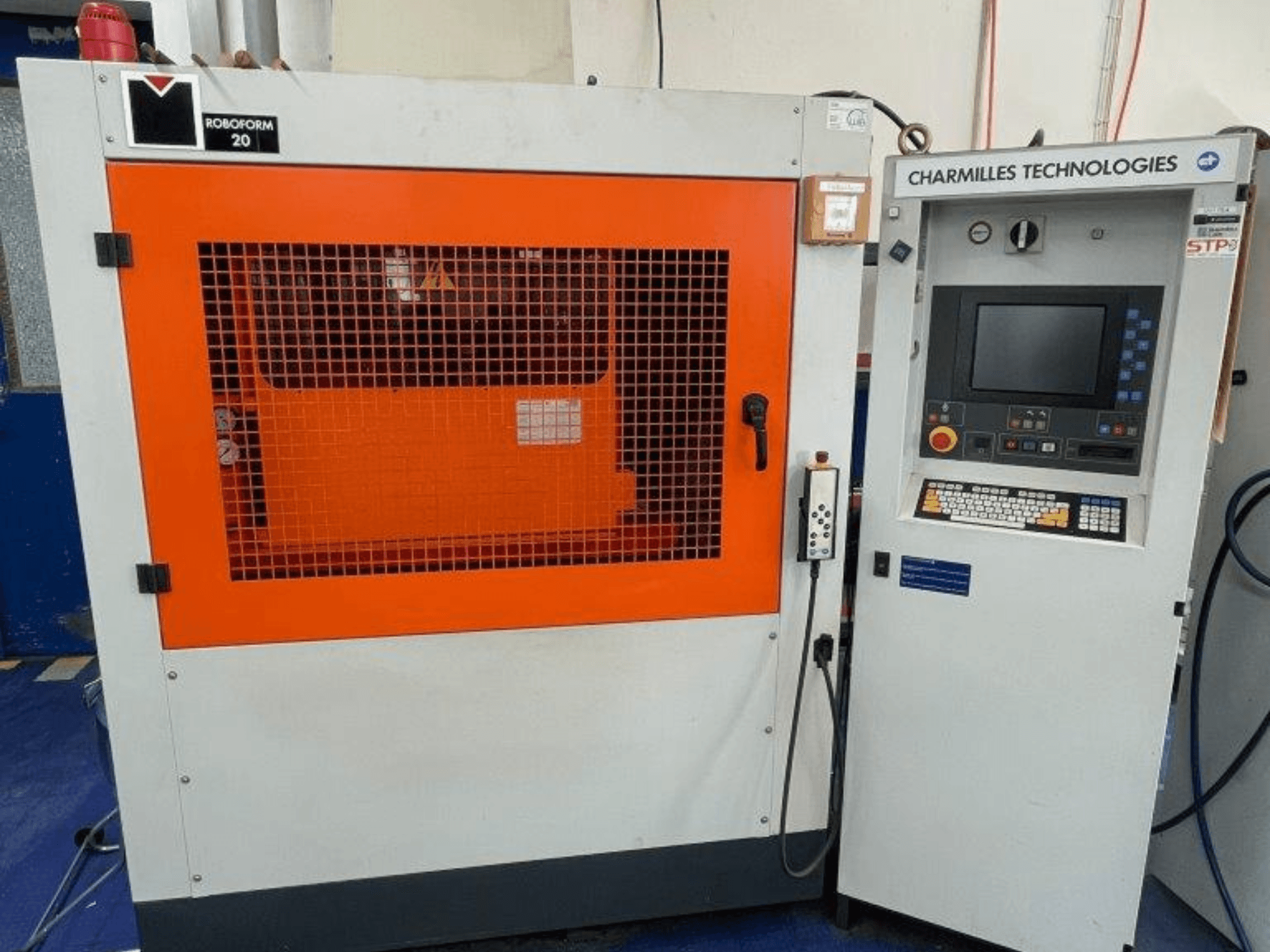 AgieCharmilles Robofrom 20 kalıp oyma EDM makinesi, kontrol paneli ve turuncu koruyucu ızgara ile önden görünüm.