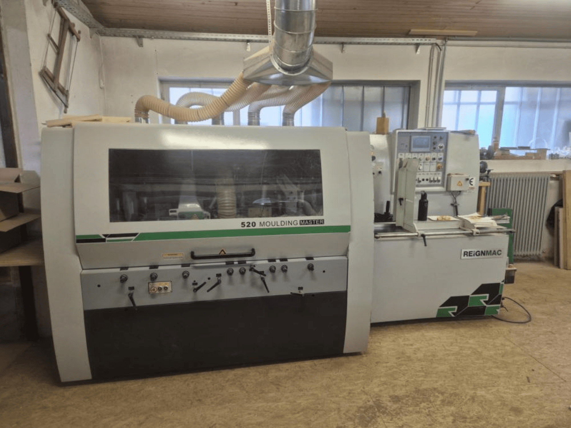 REIGNMAC 520 MOULDING MASTER ahşap planyanın önden görünümü, kontrol paneli, besleme silindirleri ve toz emme sistemi.