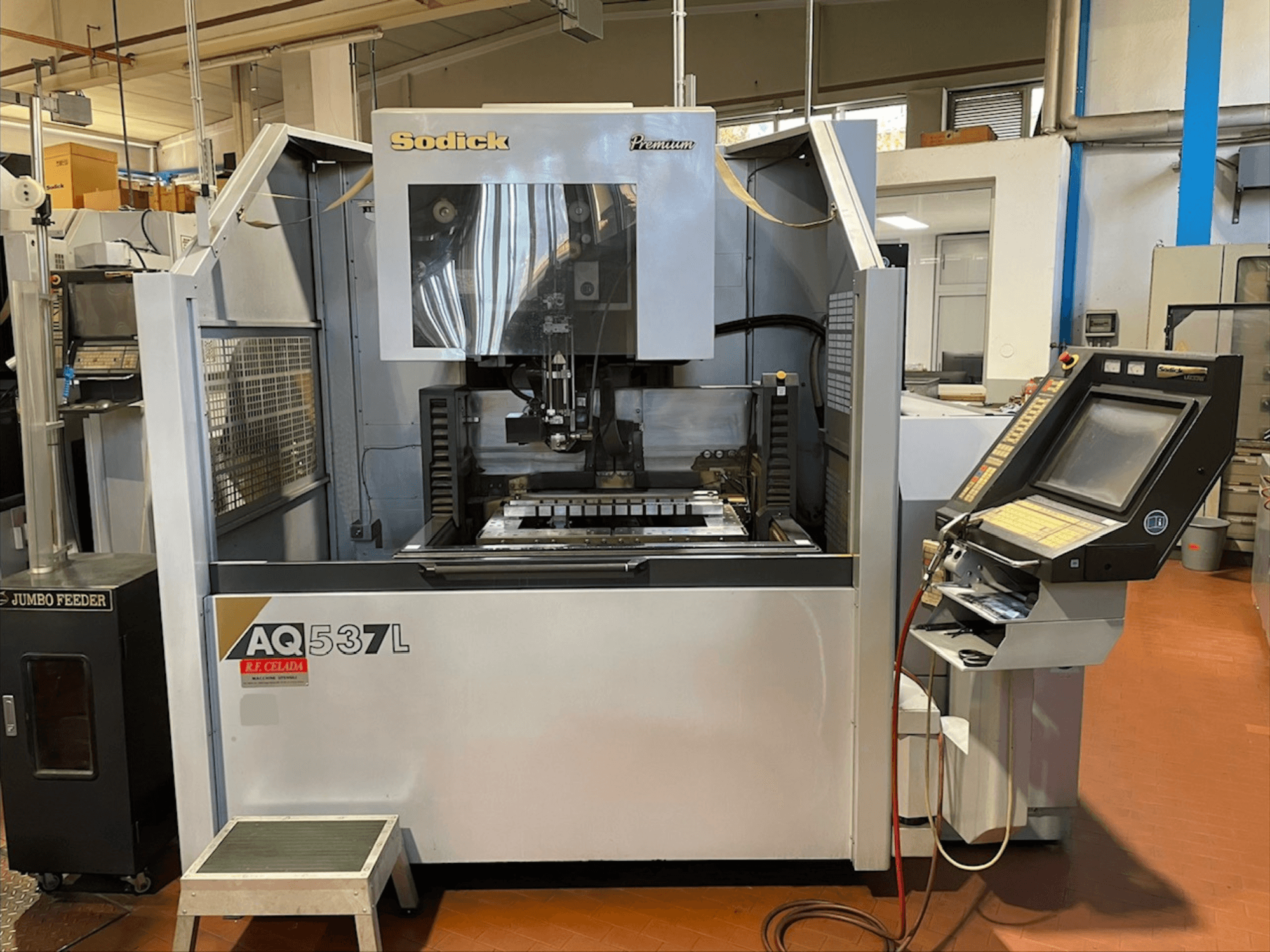 Sodick AQ537L Tel Erozyon makinesinin önden görünümü, kontrol paneli ve görünür bileşenlerle işleme alanı.