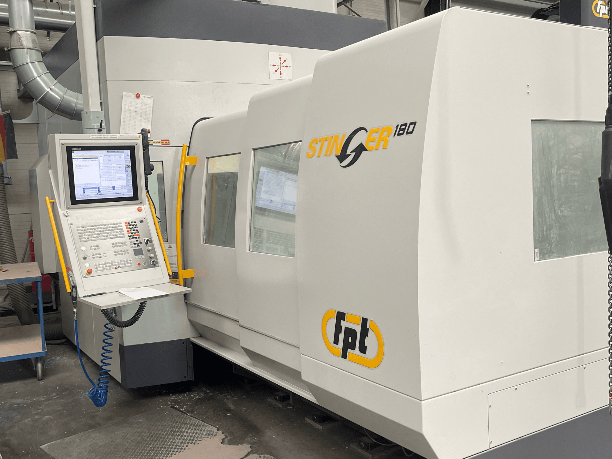 FPT STINGER 180 dikey işleme merkezinin önden görünümü; kontrol paneli ve makine özellikleri gösterilmektedir.