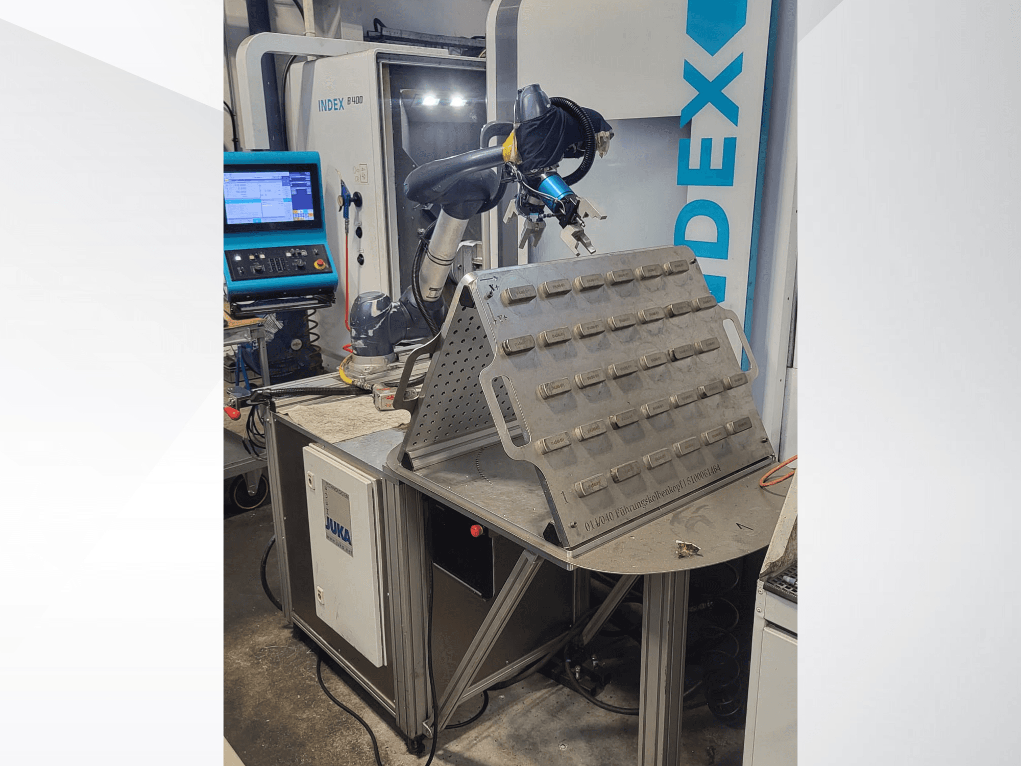 DOOSAN M1013 kolaboratif robotun önden görünümü, bir takım tutucu ve kontrol paneli ile bir çalışma masasının yanına yerleştirilmiştir.