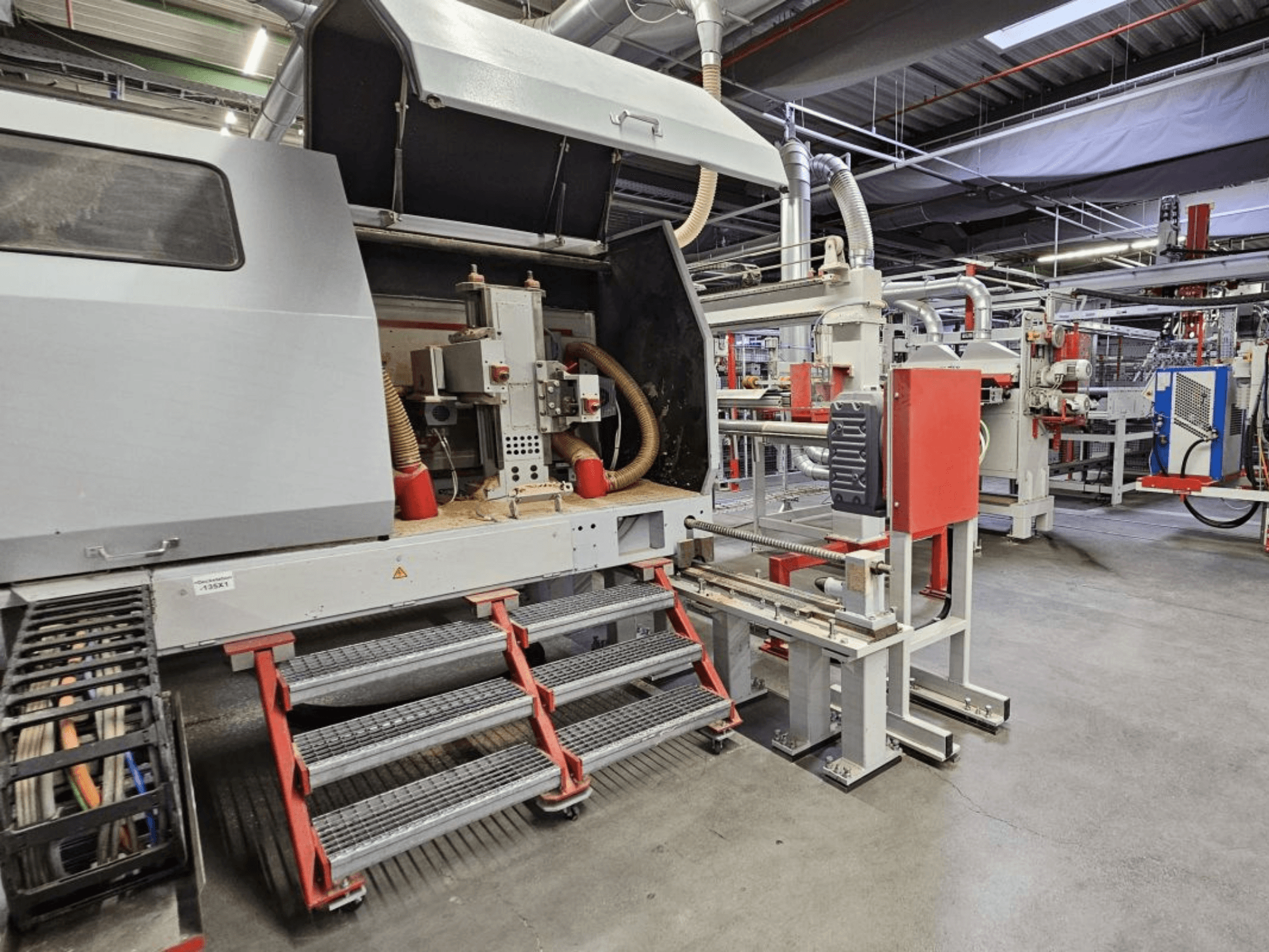 BURKLE Optima 1428/50 ahşap üretim hattının önden görünümü, basamaklar ve görünür makine bileşenleri.