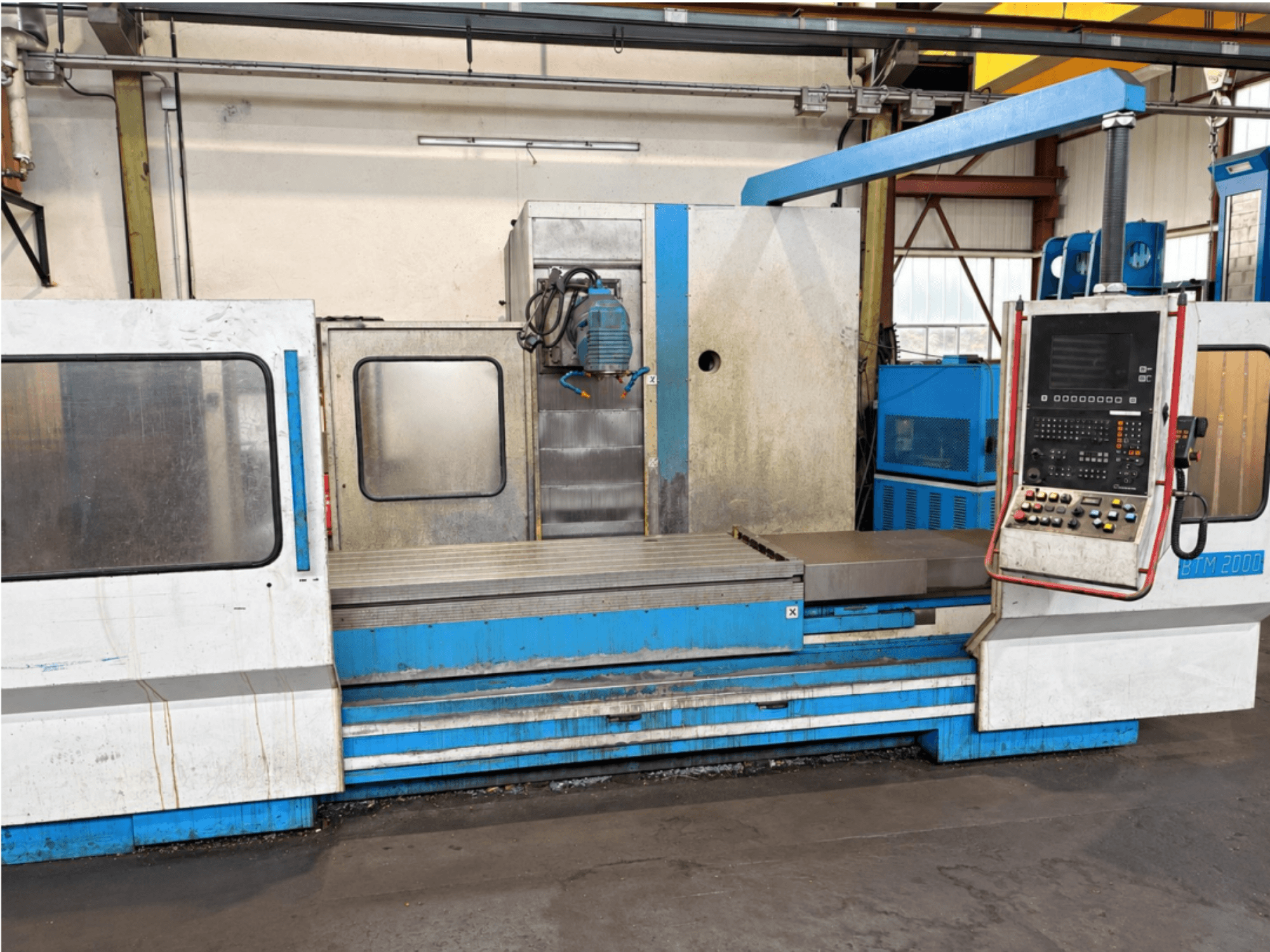 Önden bakıldığında kontrol paneli ve taşlama masasını gösteren MIKRON BTM 2000 yüzey taşlama makinesi.