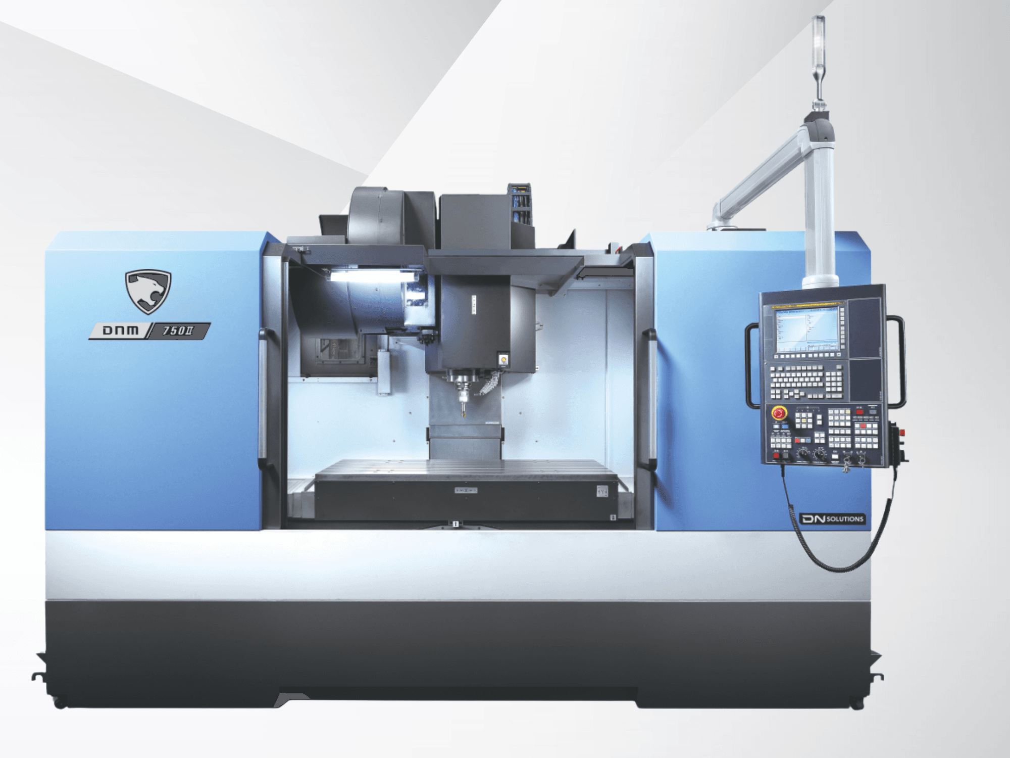 DN SOLUTIONS DNM 750 II Dikey İşleme Merkezi, önden görünüm; kontrol paneli ve açık çalışma alanı.