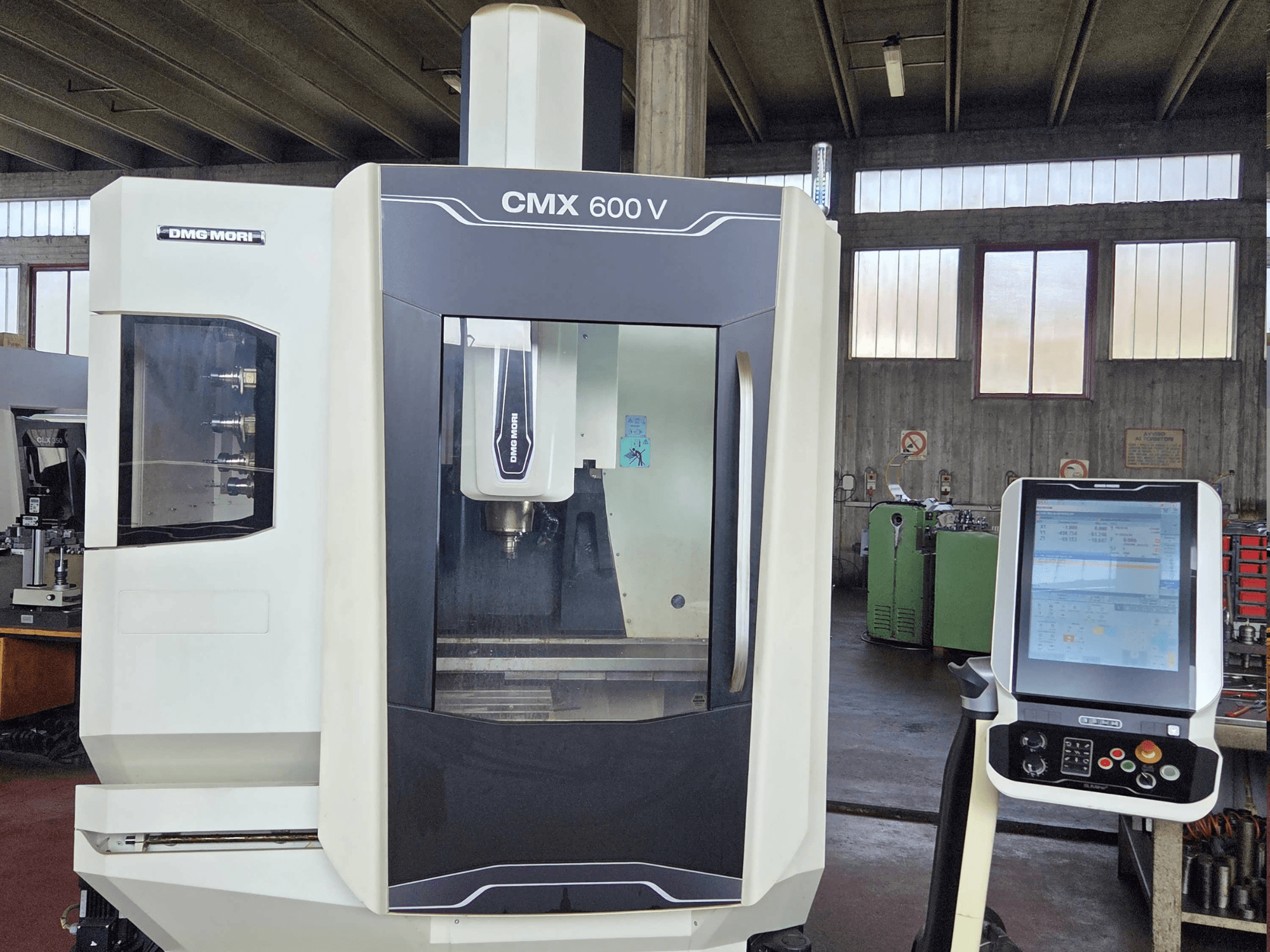 DMG MORI CMX 600V dikey işleme merkezinin önden görünümü; kontrol paneli ve iş mili bölgesinin detayları gösterilmektedir.