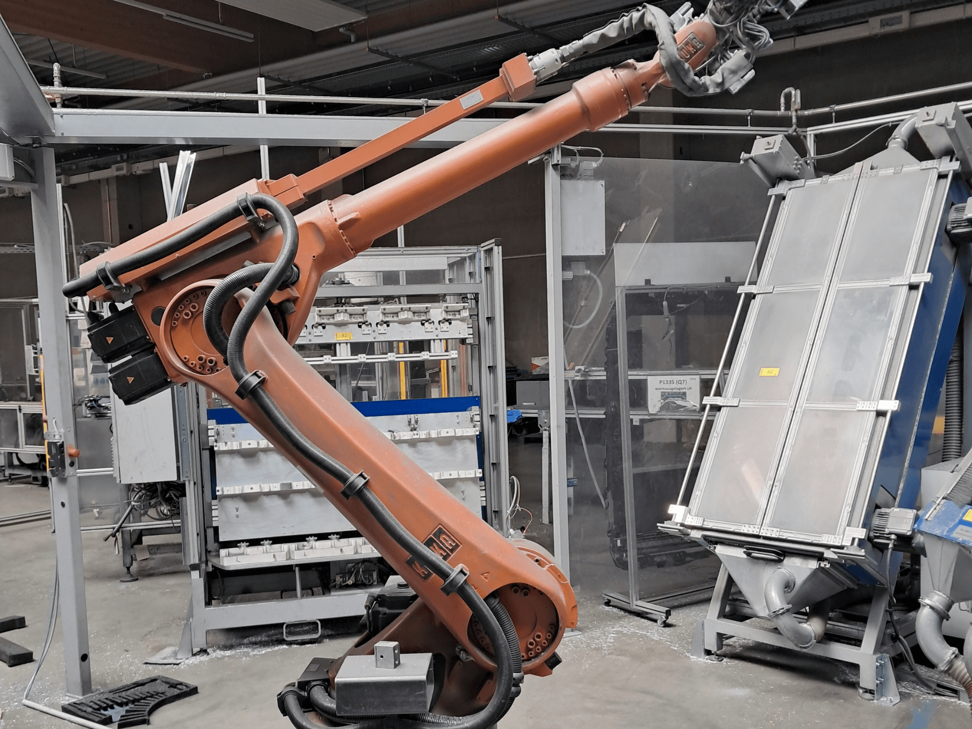 Fabrika ortamında bulunan KUKA KR 30L16-2 robot kolu; kabloları ve mekanik bileşenleri gösteren yandan görünüm.